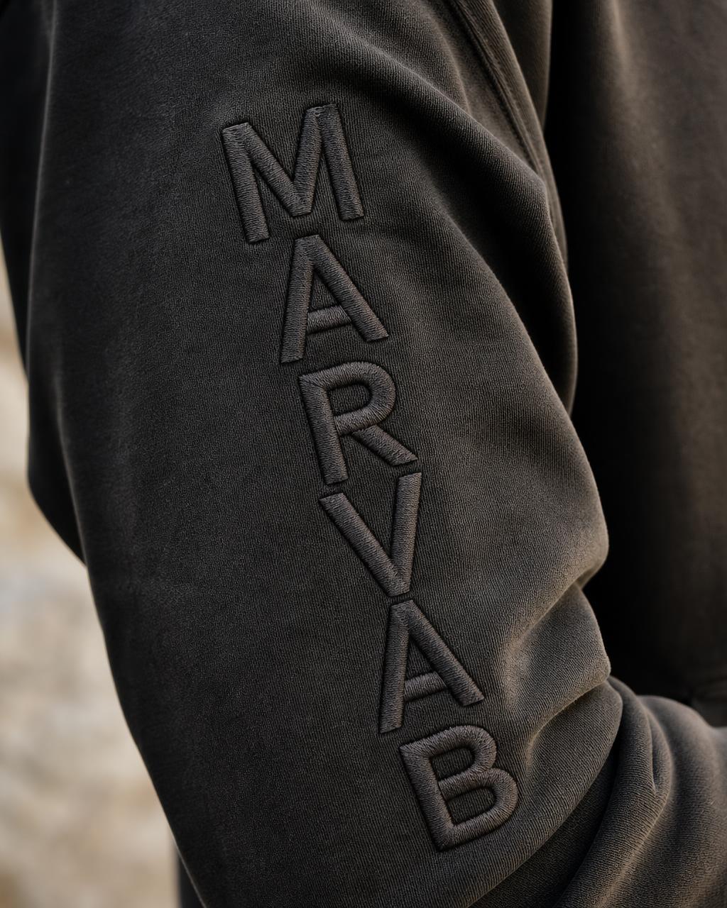 Macro of the MARVAB wordmark embroidered vertically down the left sleeve
