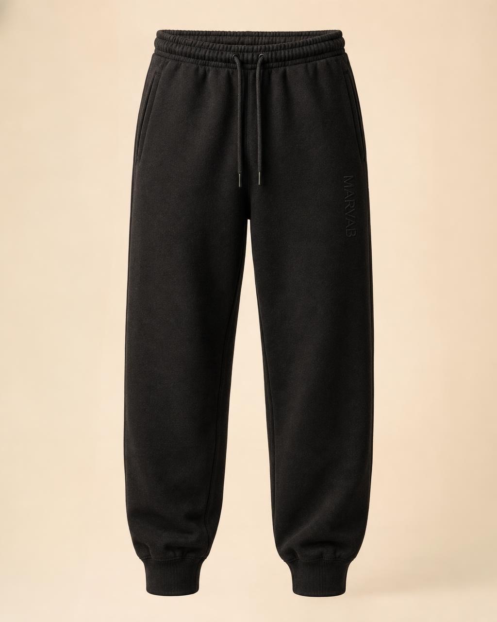 CORE 003 Joggers in Washed Black with the wordmark down the left thigh